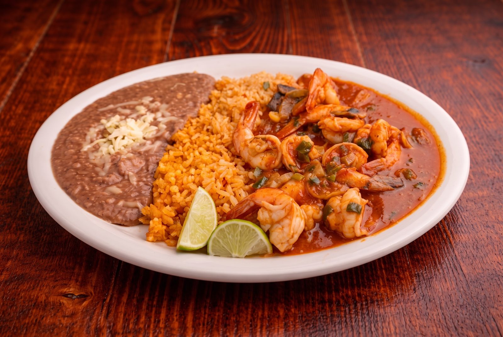 Camarones rancheros with rice, beans and lime
